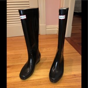Tall black hunter boots.